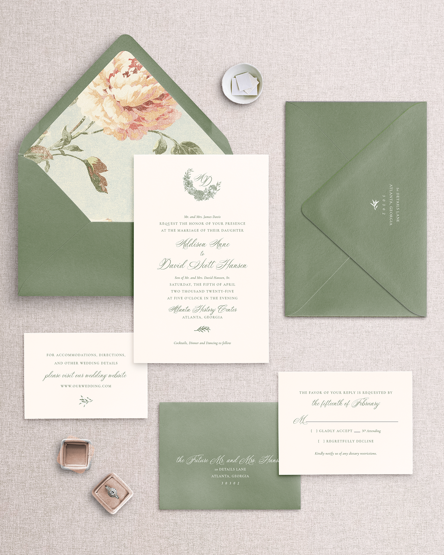 Teh Addison 5-piece wedding invitation suite including invitation card with green border, a response card, both with envelope, and an envelope liner with floral print. Shown as 1 way you can personalize this invitation suite. Items are placed on a neutral background.
