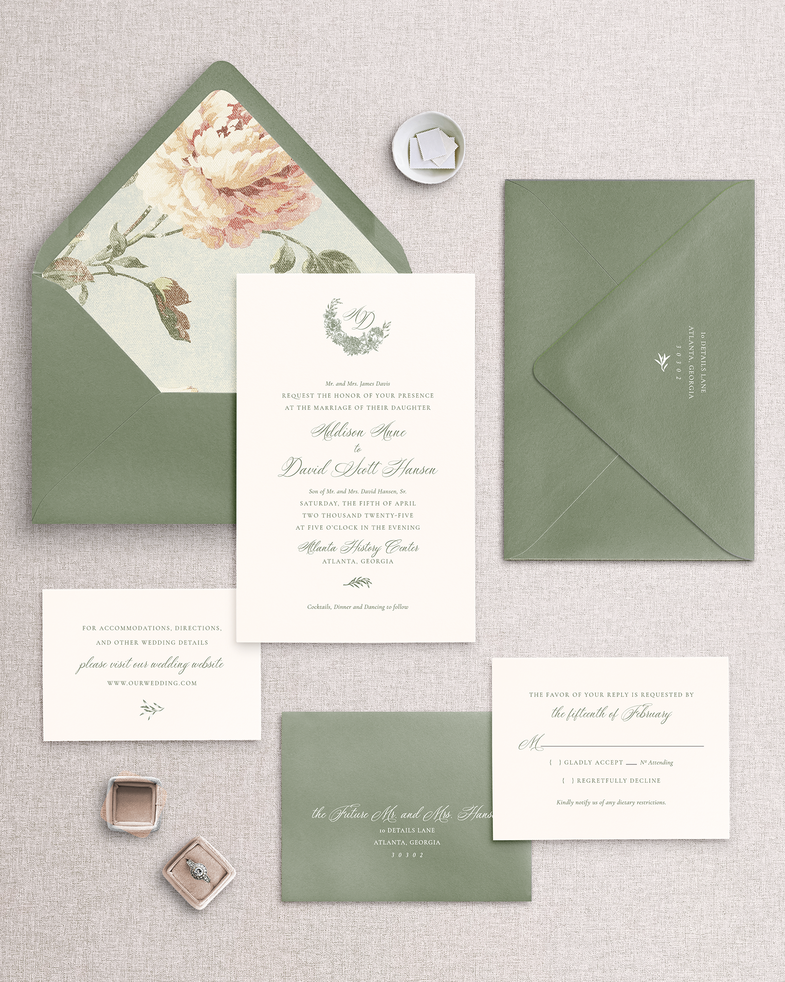 Teh Addison 5-piece wedding invitation suite including invitation card with green border, a response card, both with envelope, and an envelope liner with floral print. Shown as 1 way you can personalize this invitation suite. Items are placed on a neutral background.