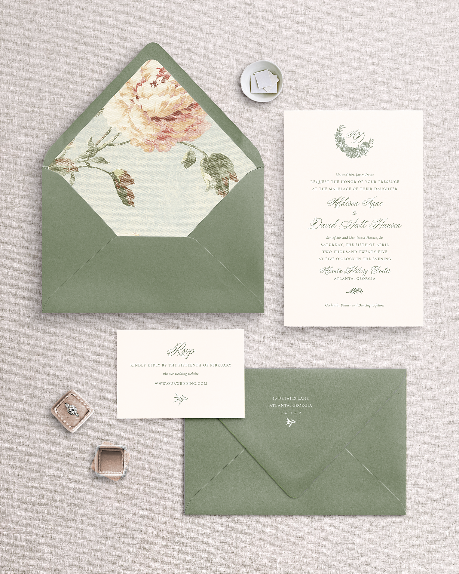 The Addison 3 piece invitation suite laid out on a surface, including a green envelope with a floral liner, a matching green invitation card, and a reply card with an envelope.