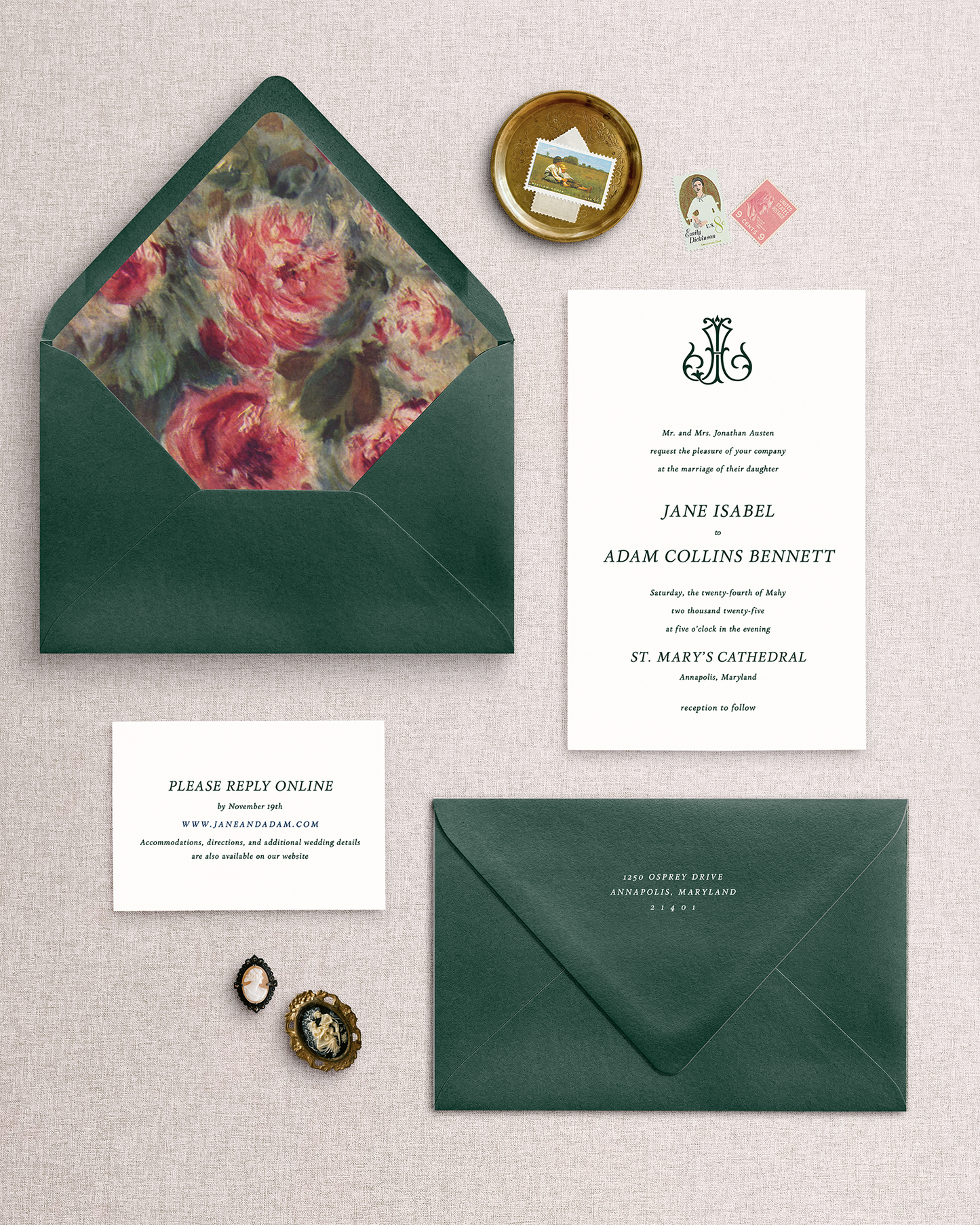 The Jane 3 piece wedding invitation set with floral envelope liner and green envelopes on a textured surface.