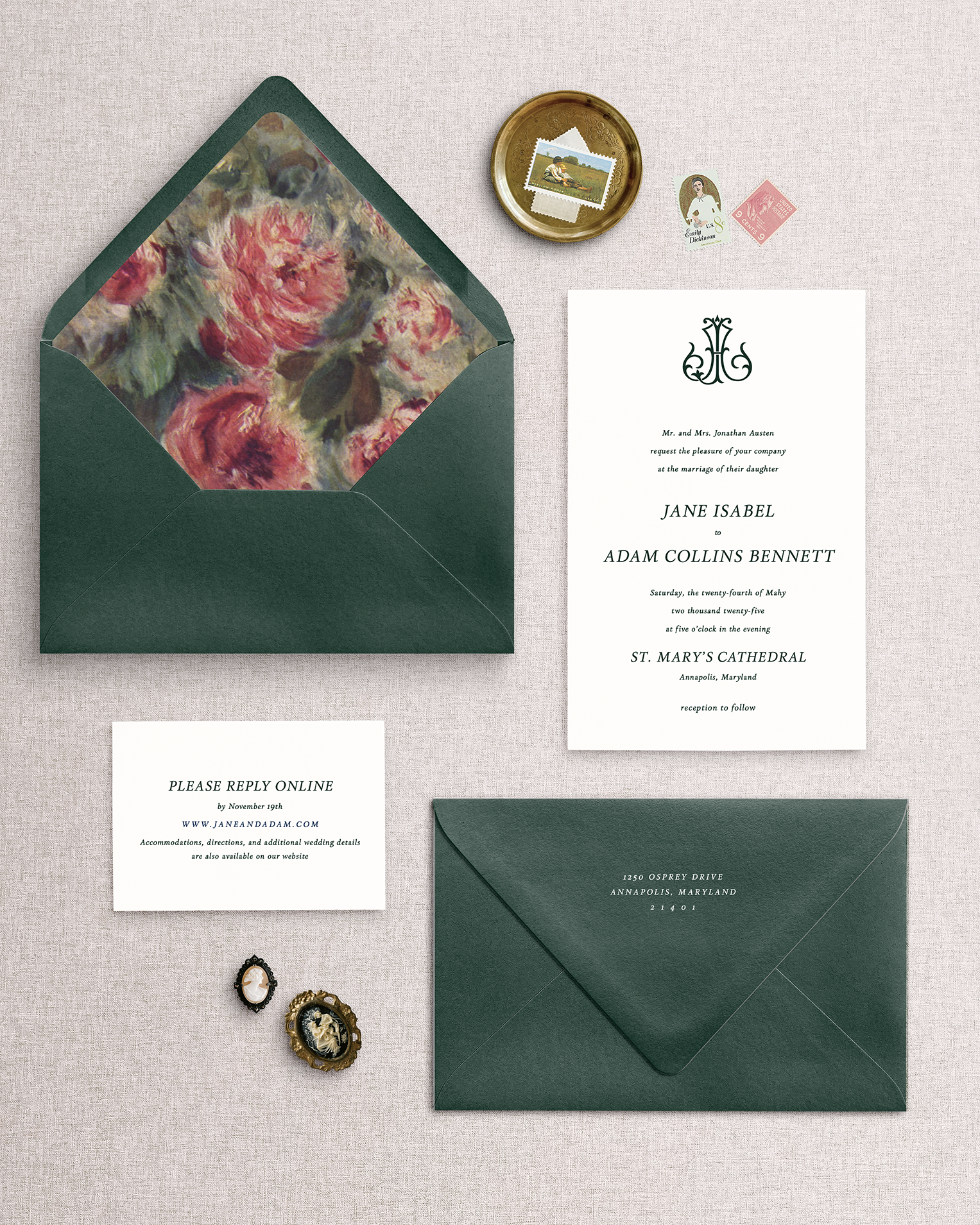 The Jane 3 piece wedding invitation set with floral envelope liner and green envelopes on a textured surface.