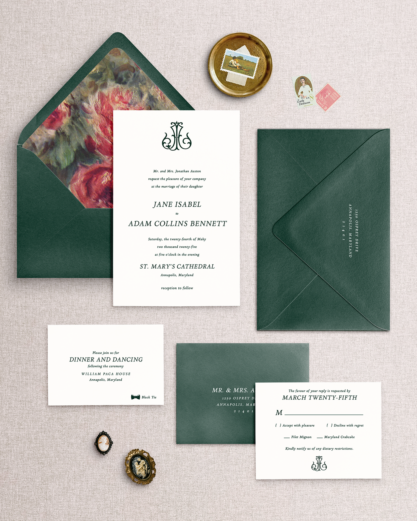 The Jane wedding invitation suite personalized with a vintage monogram, green envelopes and floral envelope liner on a textured surface.