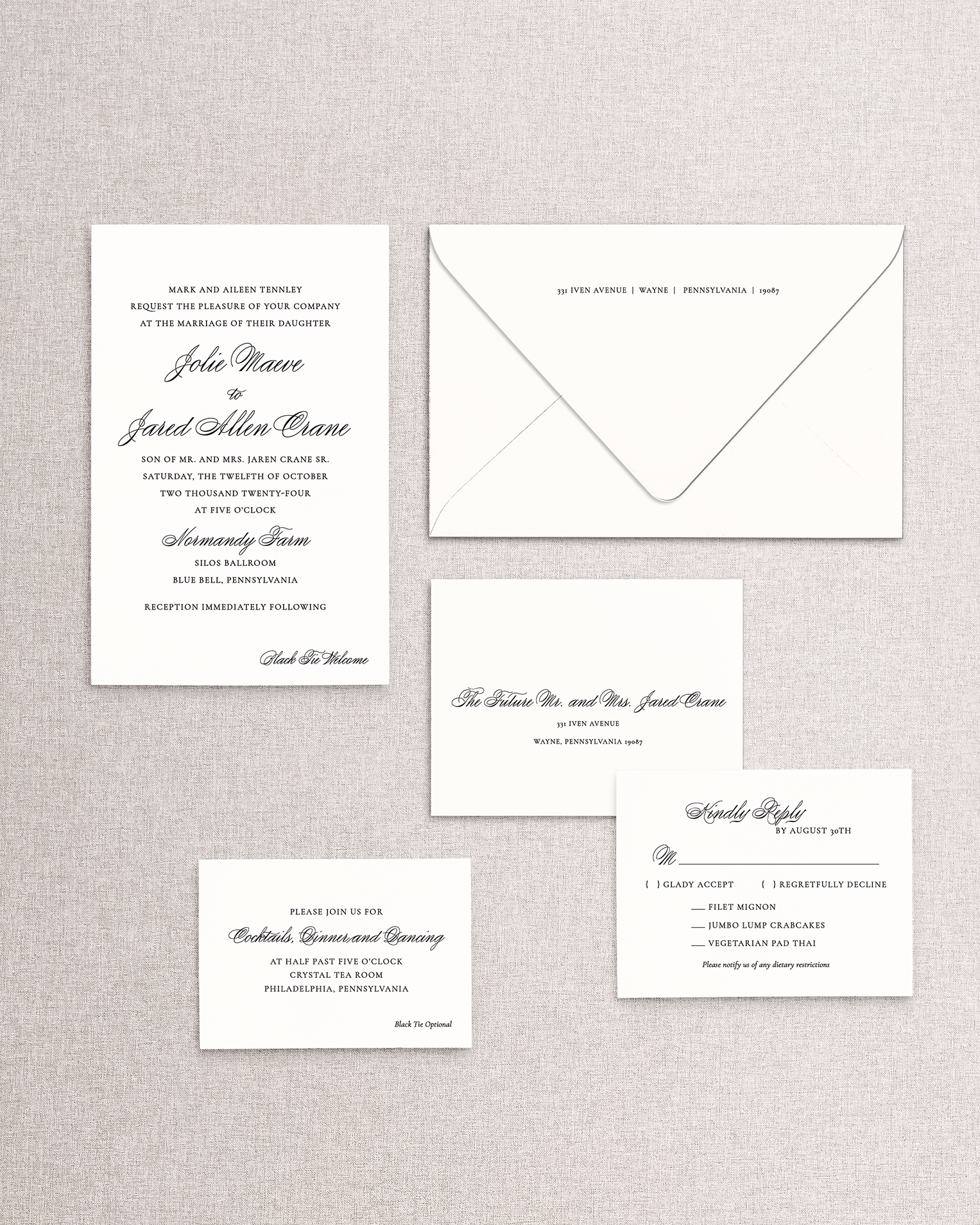 Set of wedding invitations and RSVP card on a textured gray background