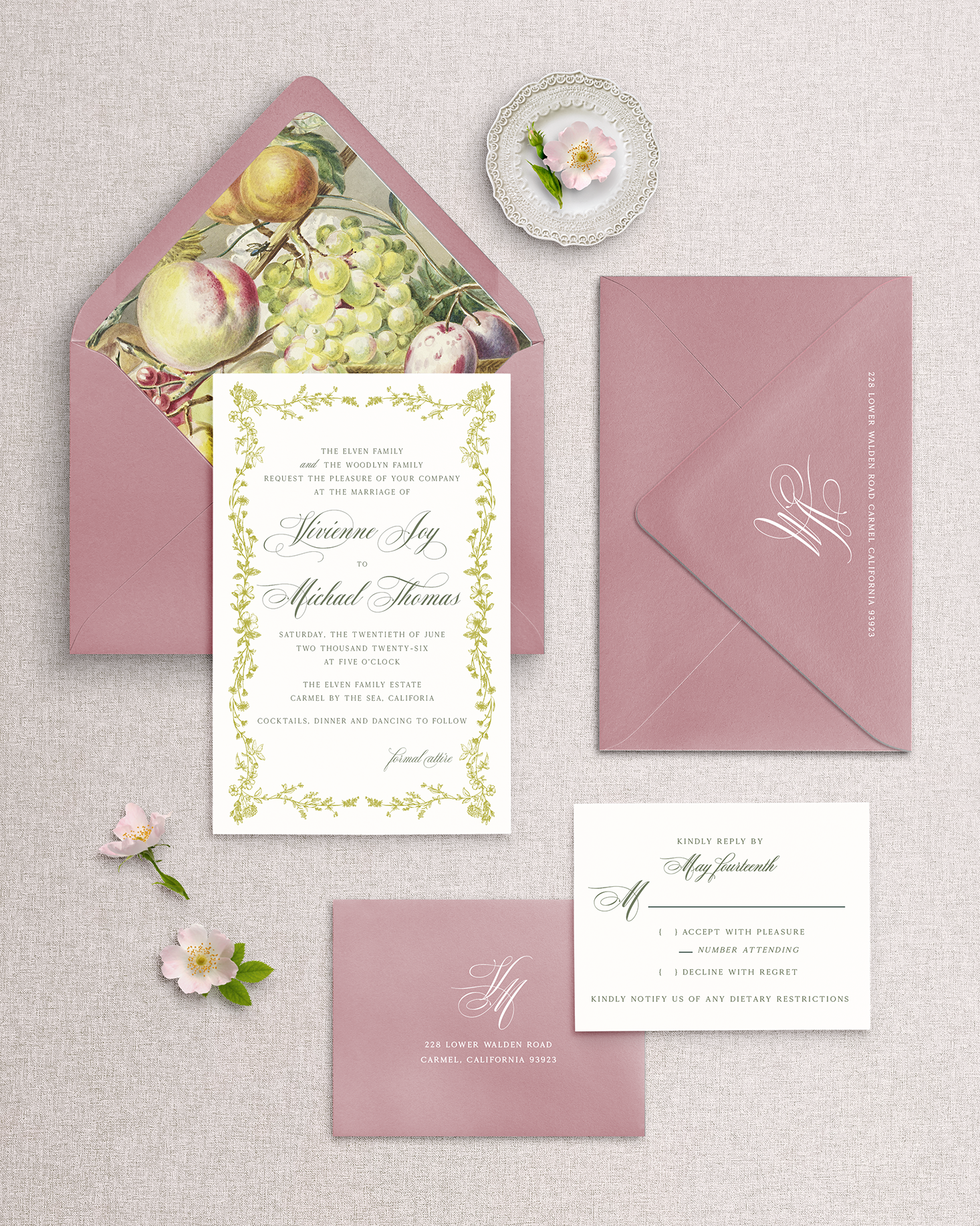 Wedding invitation set with pink envelopes and floral design on a light gray background