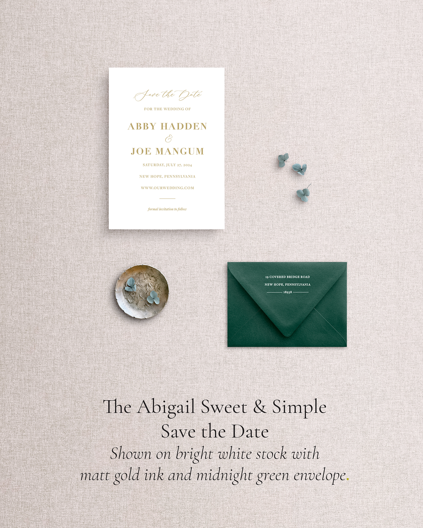 Wedding save the date card with dark green envelope on a textured gray background