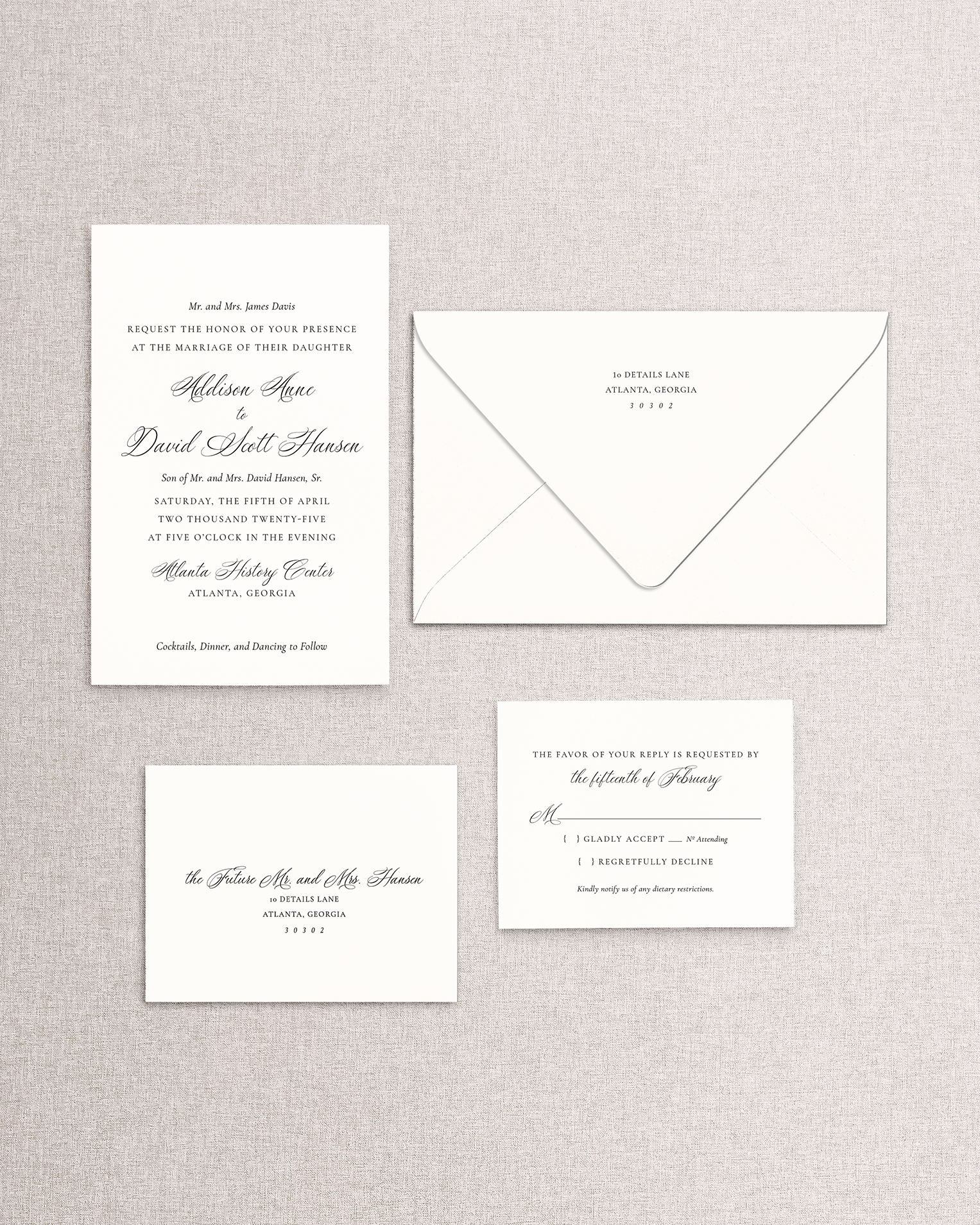 Set of wedding invitations and RSVP card on a textured gray background