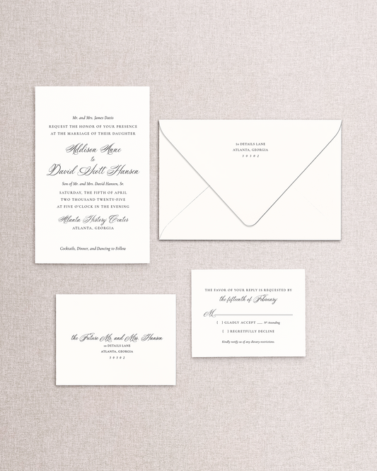 Set of wedding invitations and RSVP card on a textured gray background