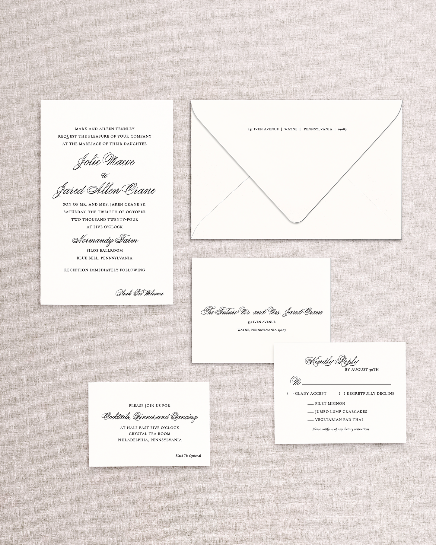 Set of wedding invitations and RSVP card on a textured gray background