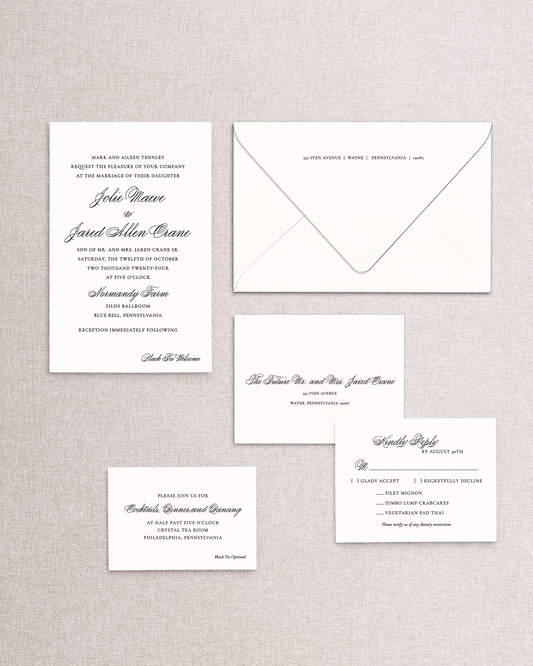 Set of wedding invitations and RSVP card on a textured gray background
