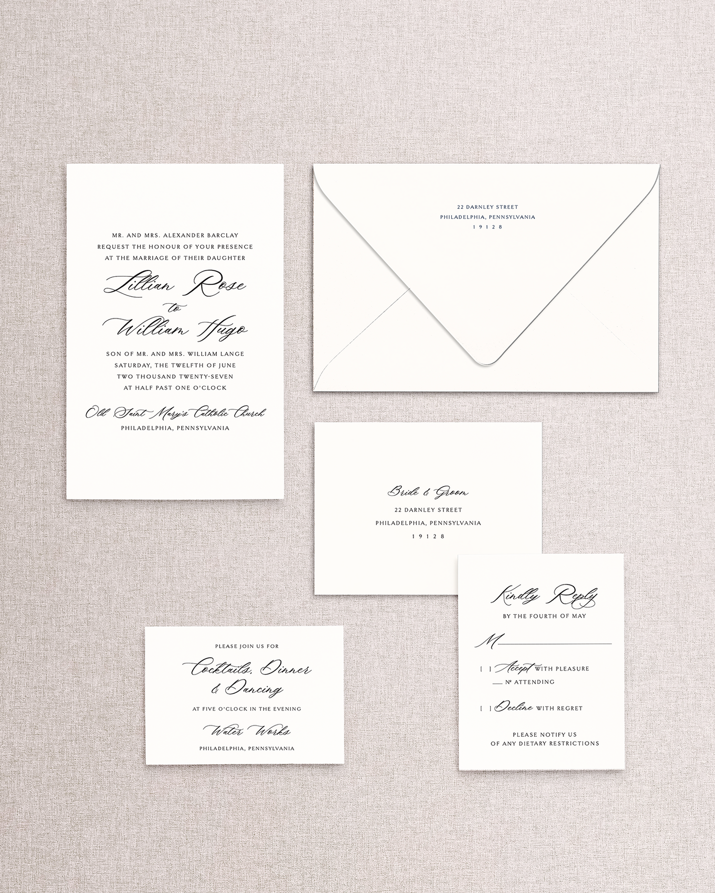 Set of formal wedding invitations and envelope on a textured gray background. Shown are the invitation and envelope, response card and envelope, and reception card from the Lillian design.
