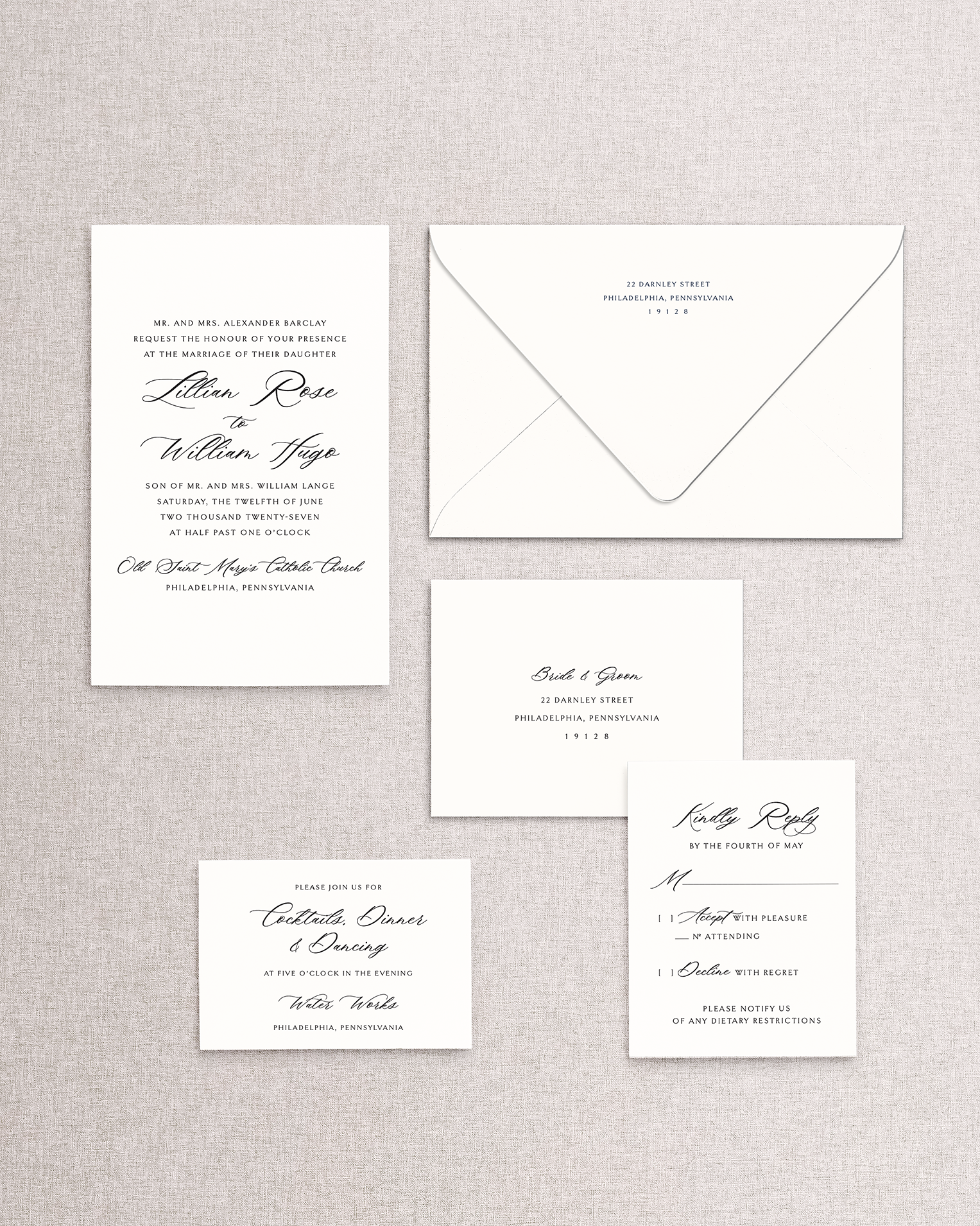 Set of formal wedding invitations and envelope on a textured gray background. Shown are the invitation and envelope, response card and envelope, and reception card from the Lillian design.
