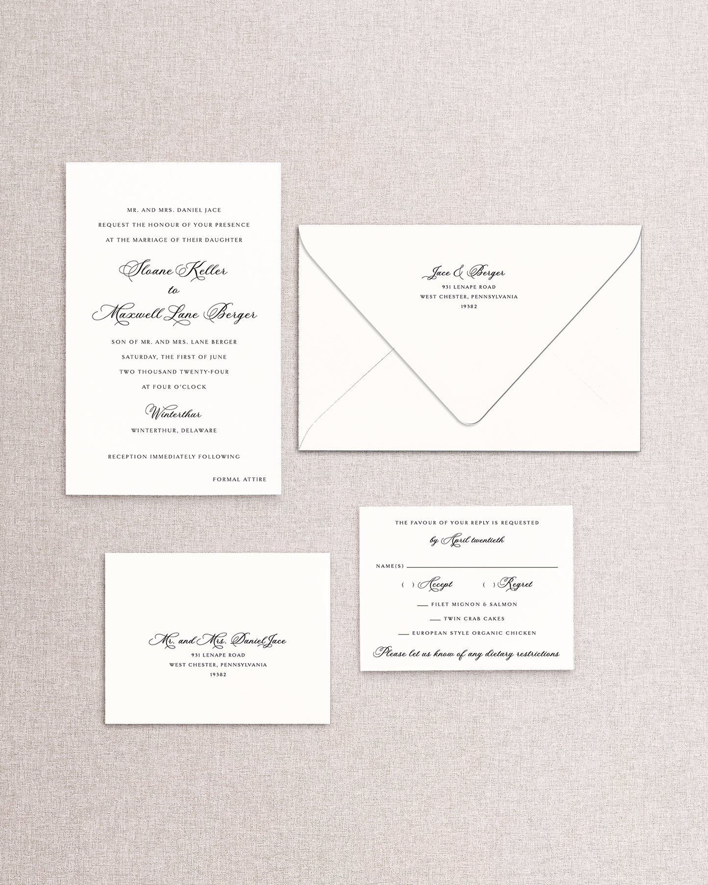 Set of wedding invitations and envelope and response card an envelope on a textured gray background. The 4 piece Sloane invitation suite from Stone Hill Paperie