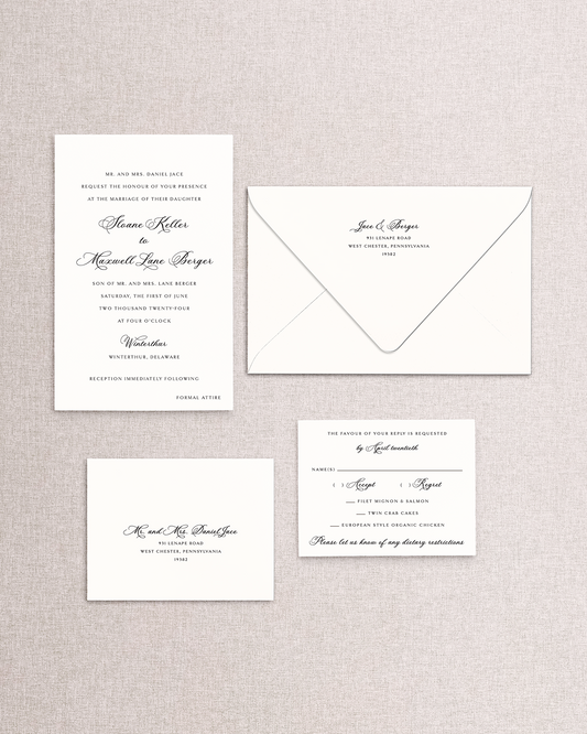 Set of wedding invitations and envelope and response card an envelope on a textured gray background. The 4 piece Sloane invitation suite from Stone Hill Paperie
